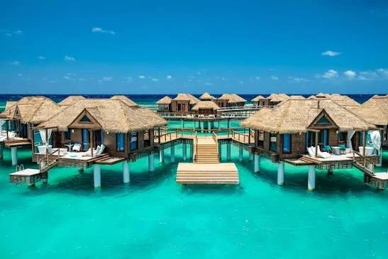 Overwater villas above turquoise water