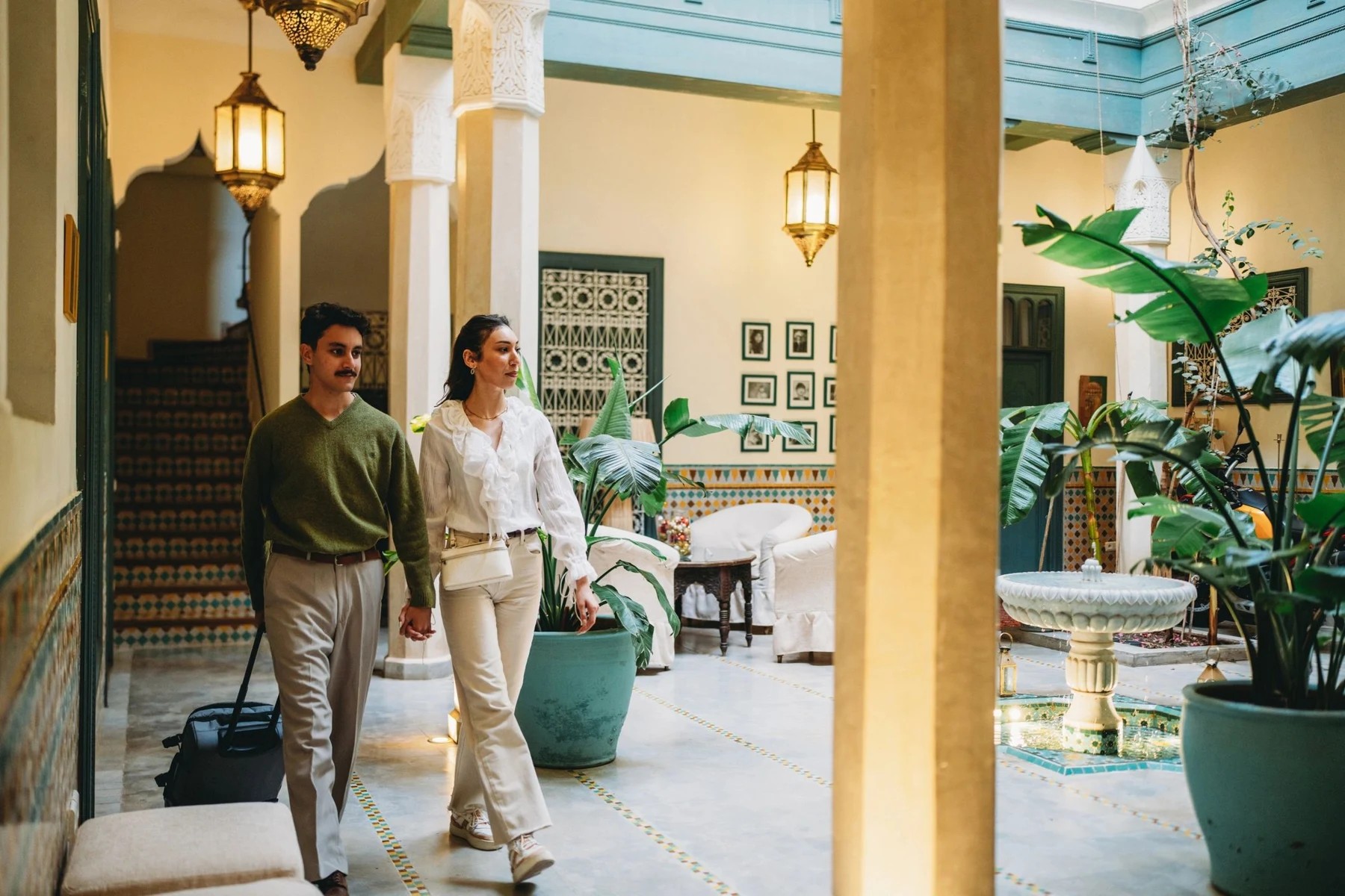 Couple arriving at a luxury hotel with luggage