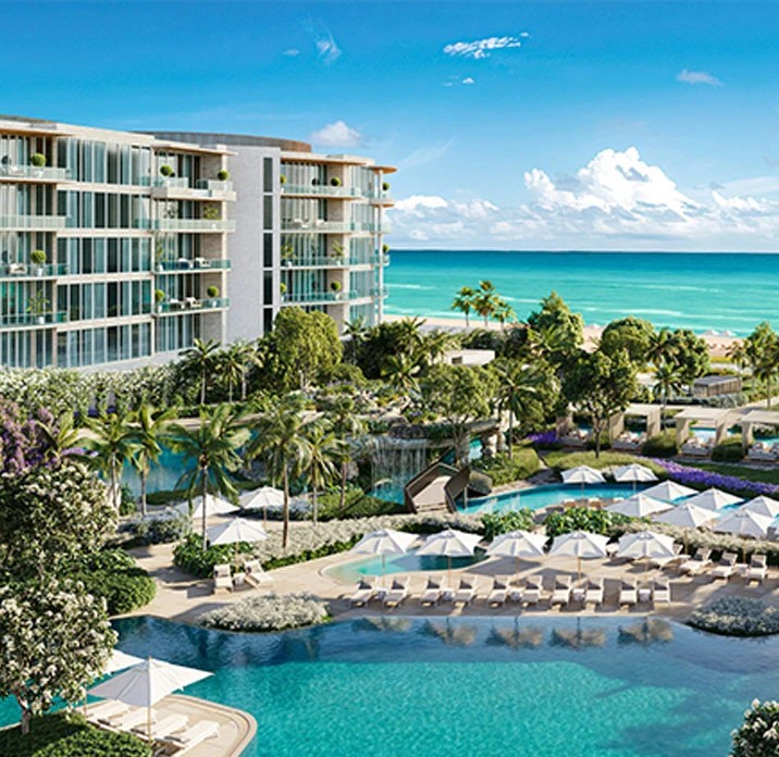 Oceanfront resort with palm-lined pools