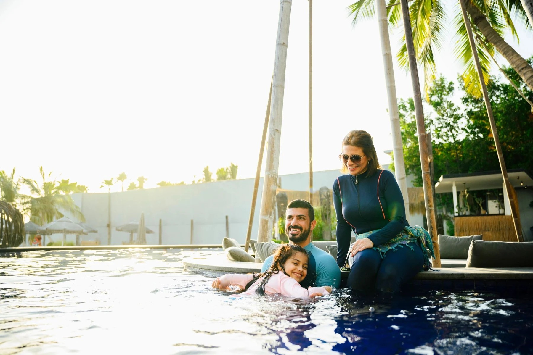 Family enjoying time by a resort pool