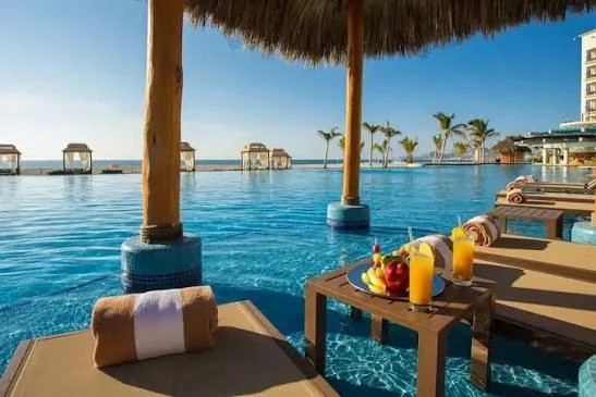 Tropical drinks beside an oceanfront infinity pool