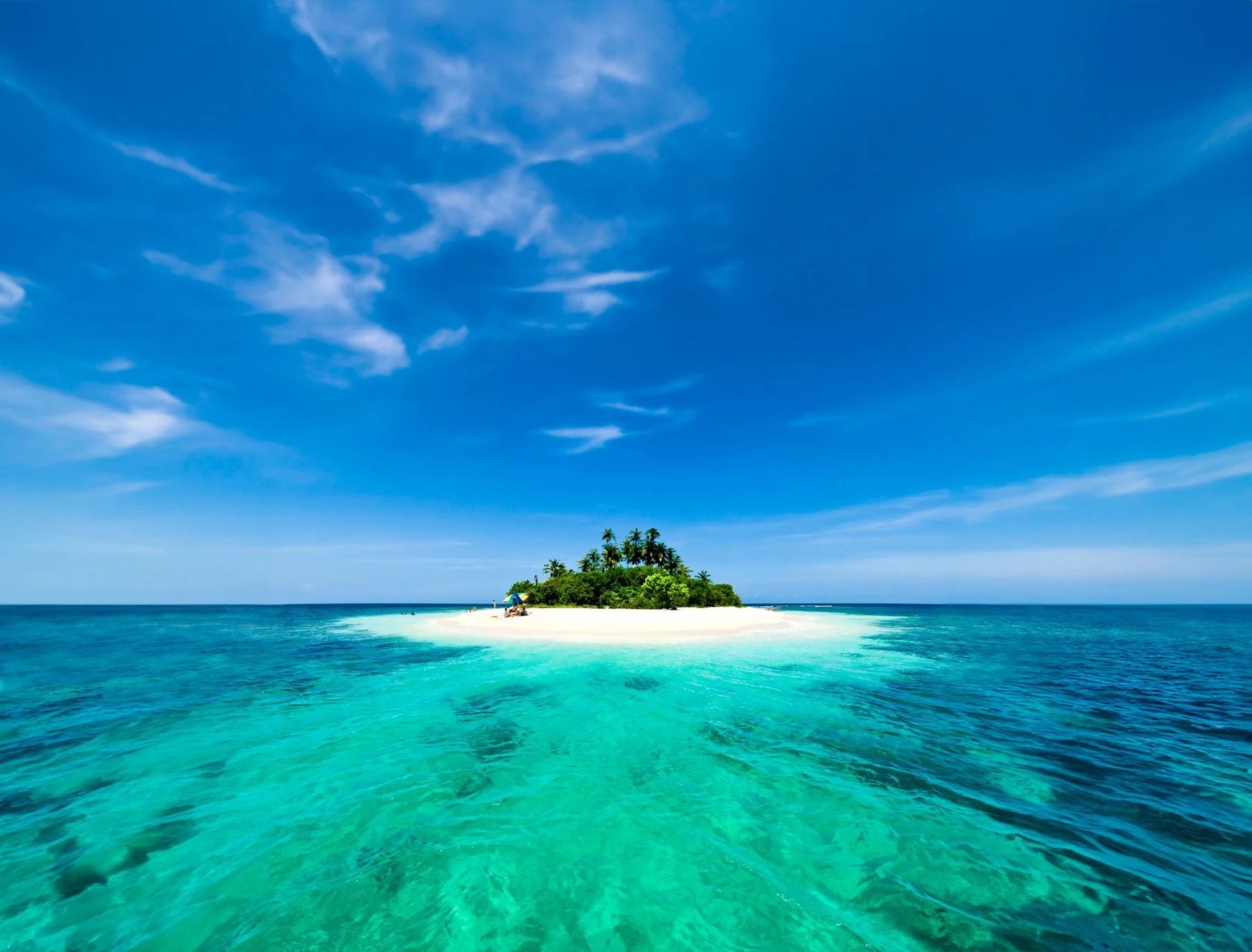 Tiny tropical island surrounded by turquoise water