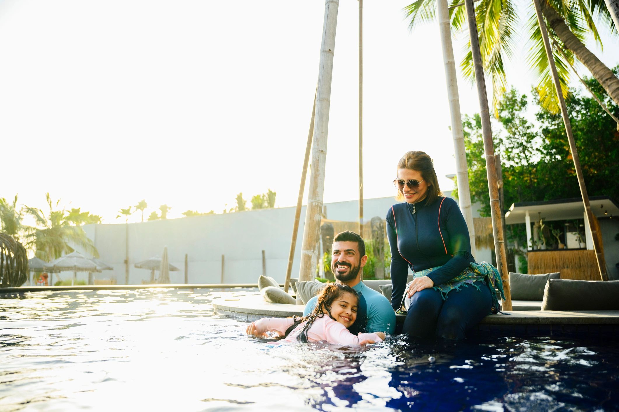 Family enjoying time by a resort pool
