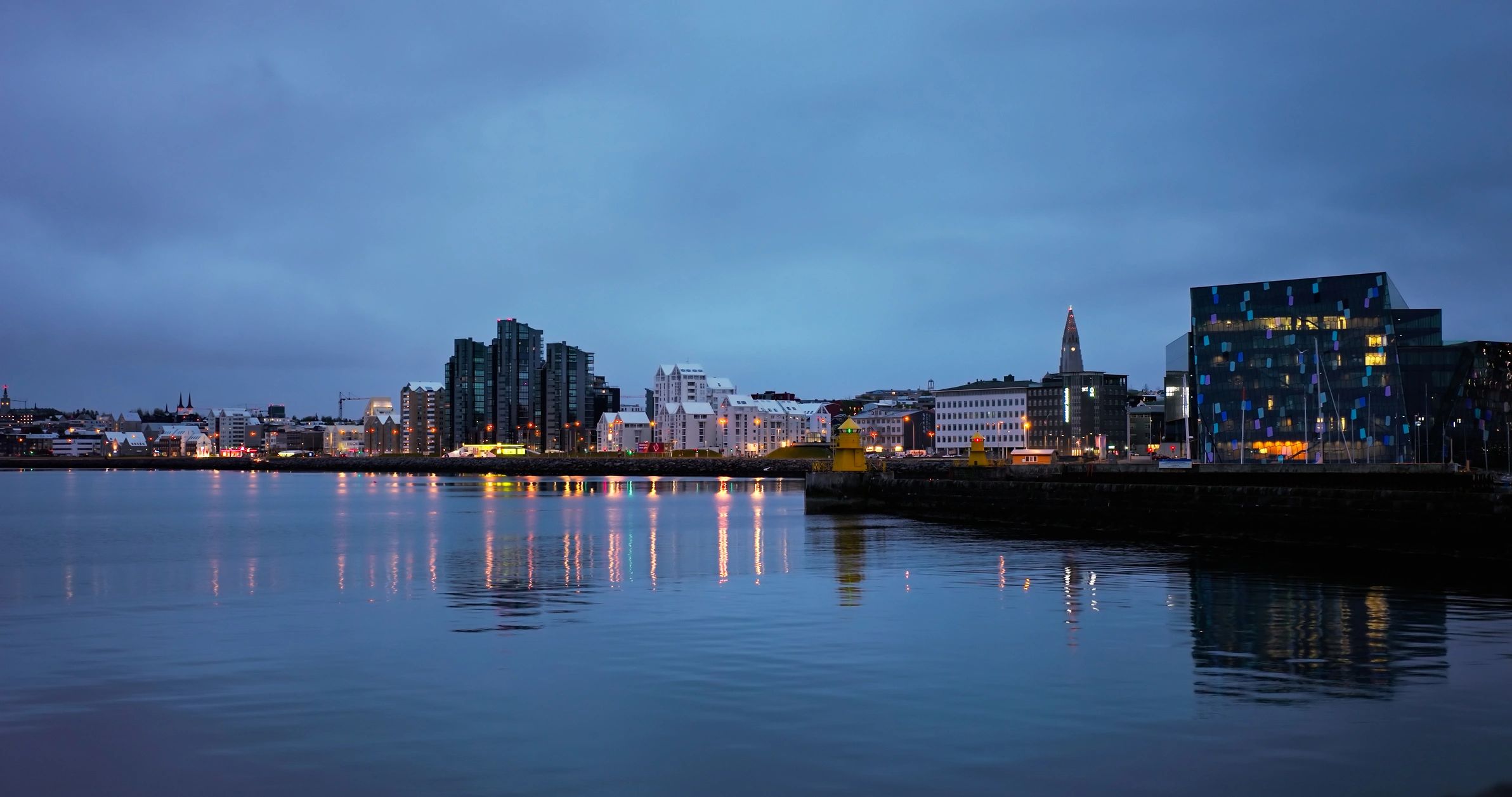 City waterfront skyline at night, representing a luxury city hotel escape