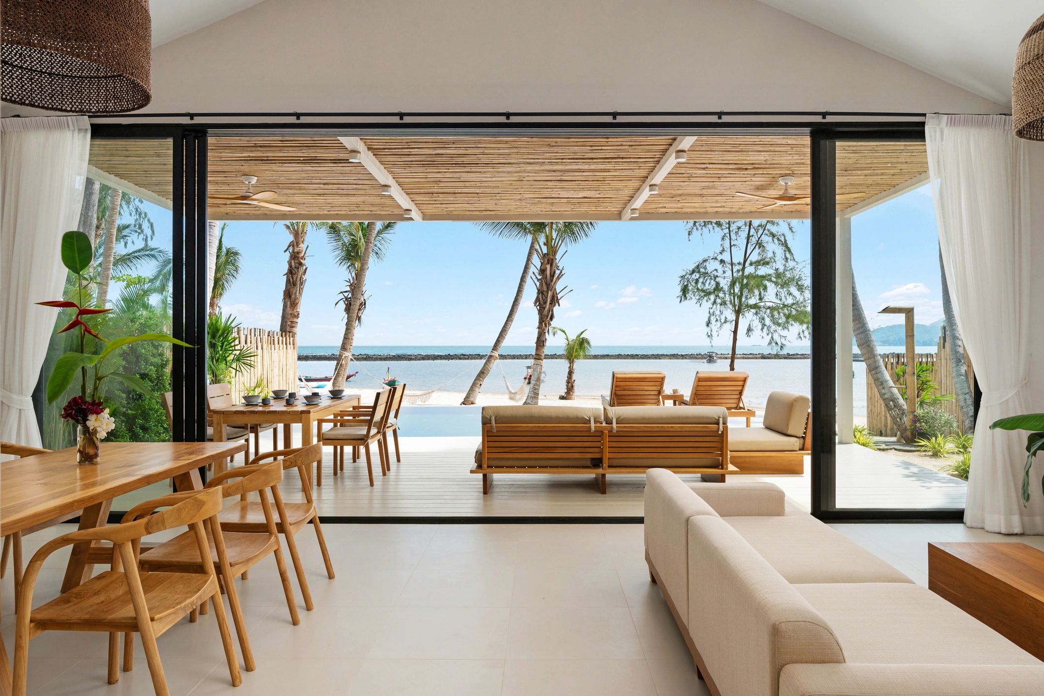 Modern luxury villa interior with ocean view, representing beachfront resort living