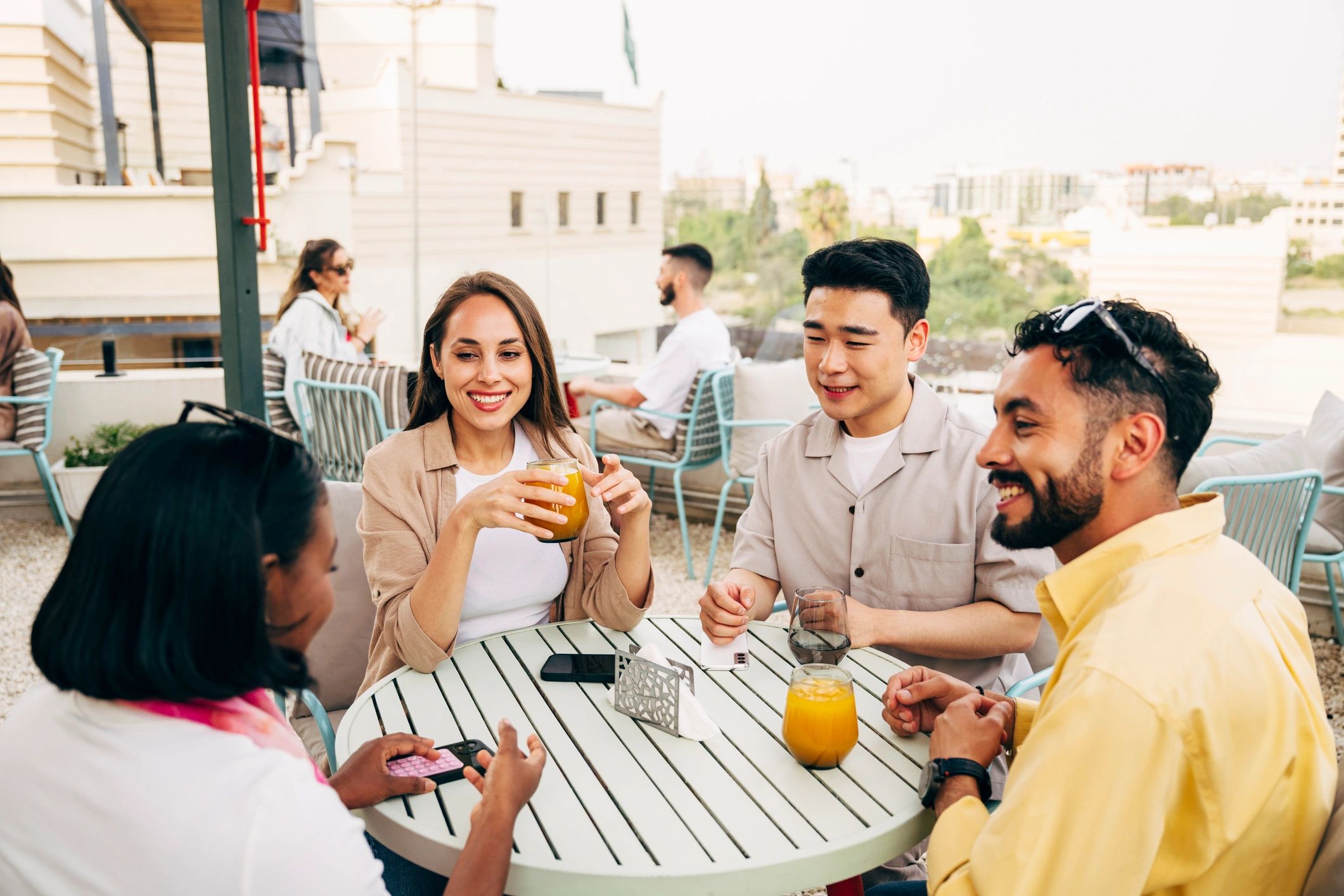 Traveler enjoying drinks on a rooftop terrace