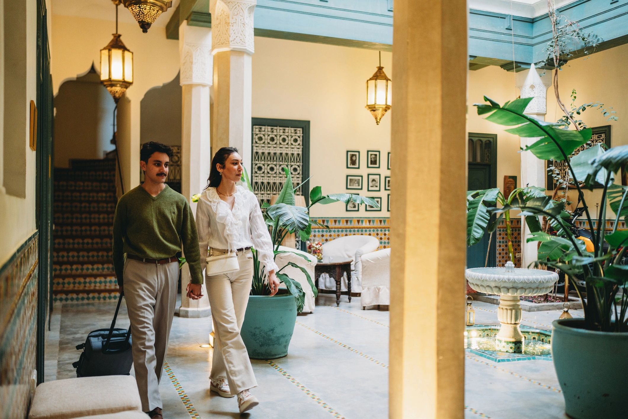 Couple arriving at a luxury hotel with luggage